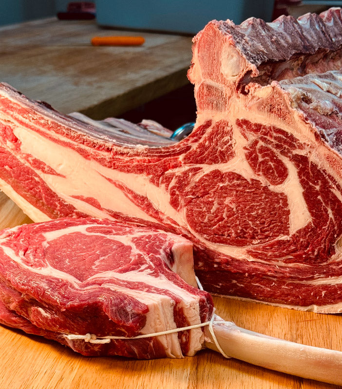 Locally sourced AAA Tomahawk Steak with rich marbling, perfect for reverse-searing or grilling to create a tender and flavorful meal