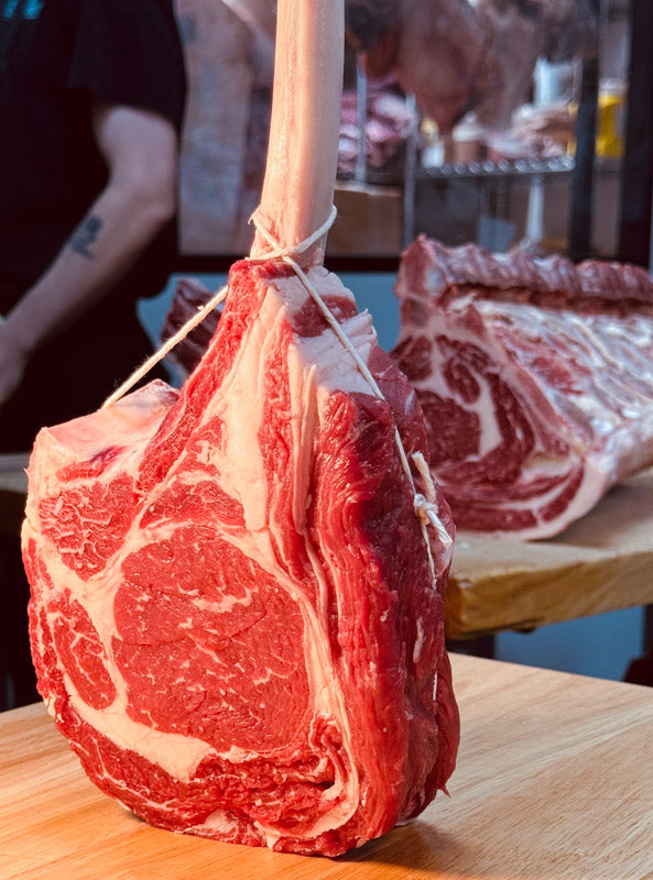 Bone-in Tomahawk Steak sourced from West Grey Premium Beef, showcasing a long rib bone and ideal for sharing at gatherings